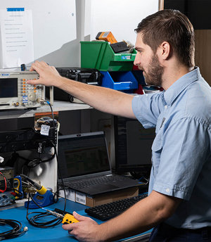 Comtel team member operating telecommunication equipment