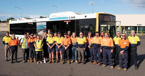 Comtel team standing in front of bus