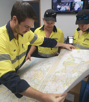Comtel team members looking at a map